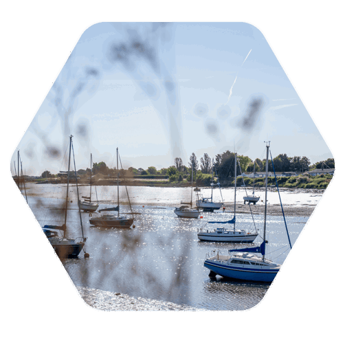Boats docked in a body of water on a sunny day with blue sky