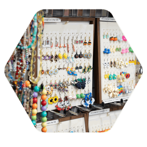 A board with many rows of decorative earrings displayed for a market stall