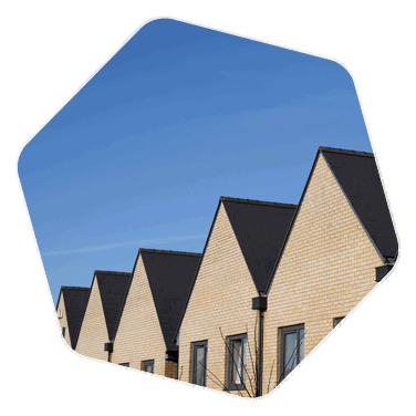 New build houses lined next to each other, black roofed with neutral coloured bricks