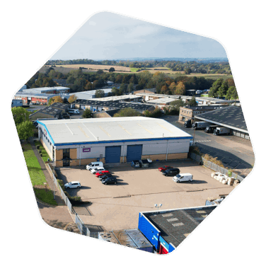 A drone shot of Waltham Road Employment Area, shows a large warehouse style building with cars parked out front 